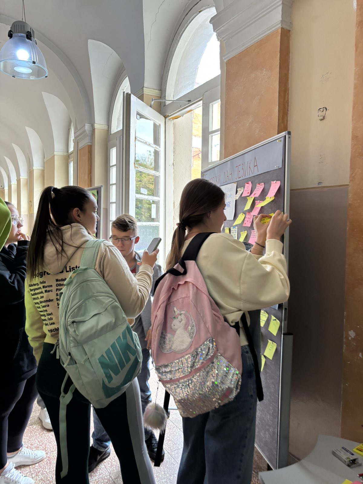 A group of people standing in a hallway
AI-generated content may be incorrect.
