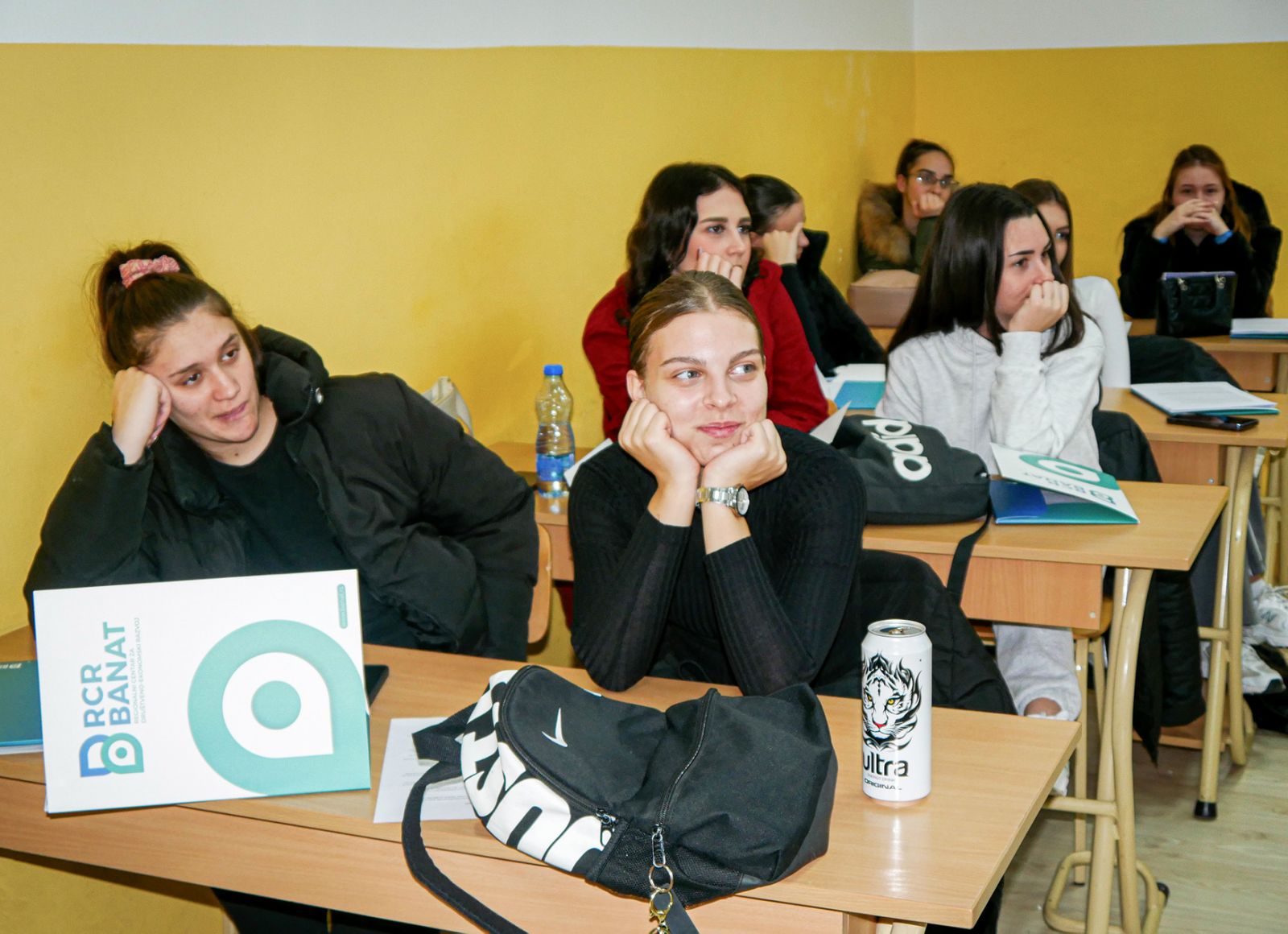 A group of people sitting at desks in a classroom

AI-generated content may be incorrect.