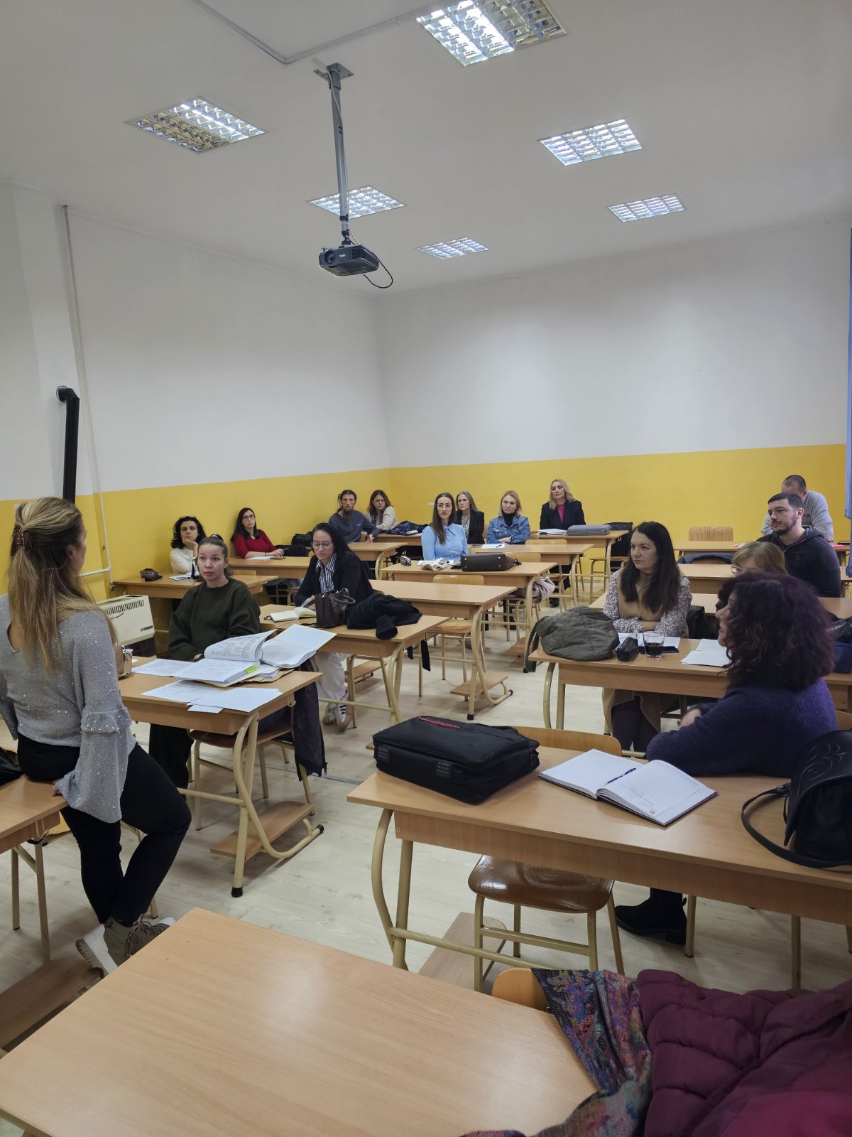 A group of people sitting at desks in a classroom
AI-generated content may be incorrect.