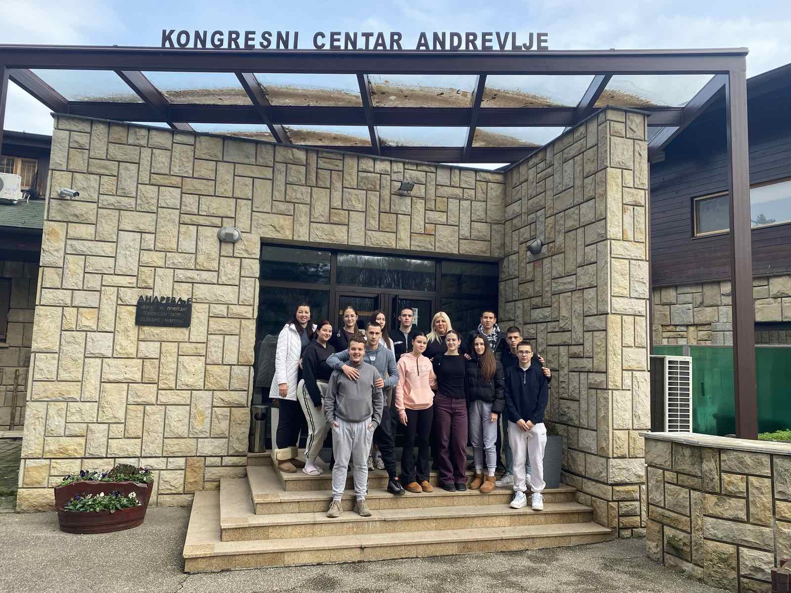 A group of people standing in front of a building
AI-generated content may be incorrect.