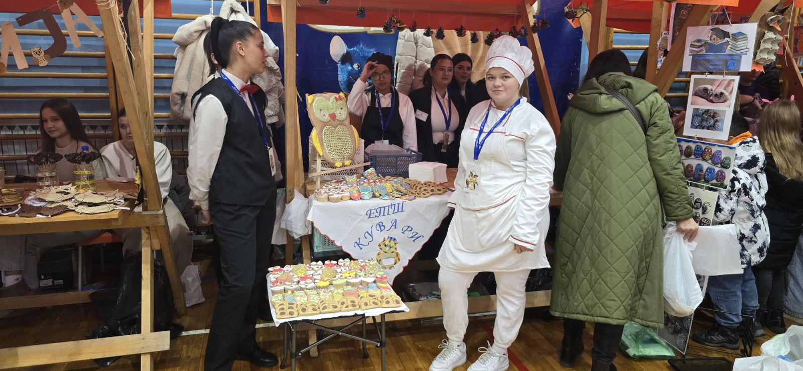 A group of people standing next to a table with food

AI-generated content may be incorrect.