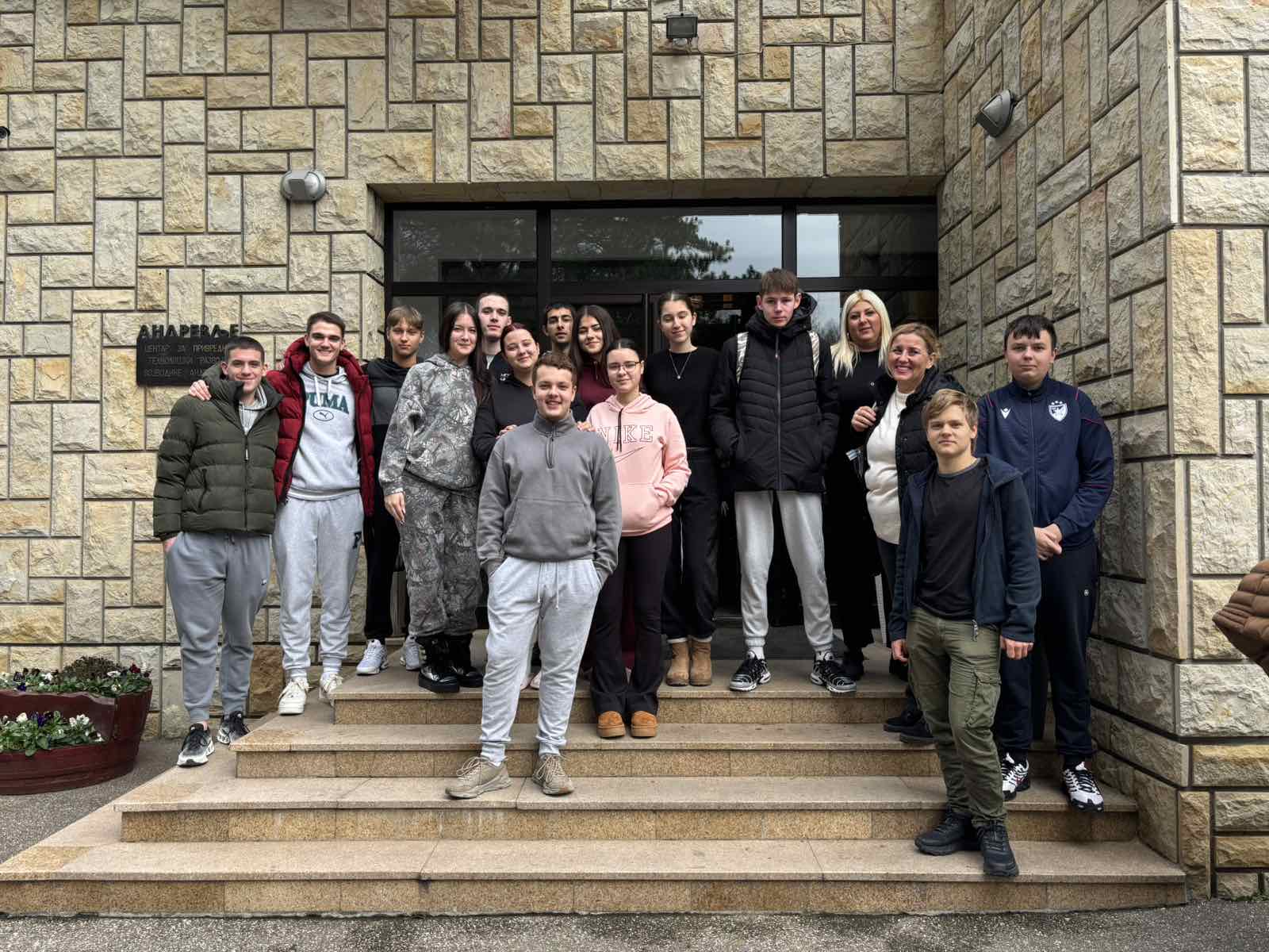 A group of people standing on steps in front of a building
AI-generated content may be incorrect.