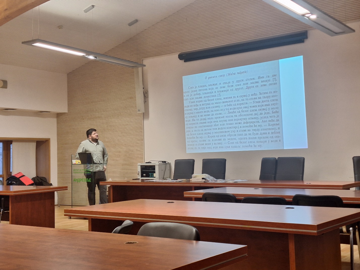 A person standing in front of a projector screen
AI-generated content may be incorrect.